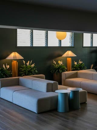 Hotel Lobby with gray sofas, wood floors and green walls