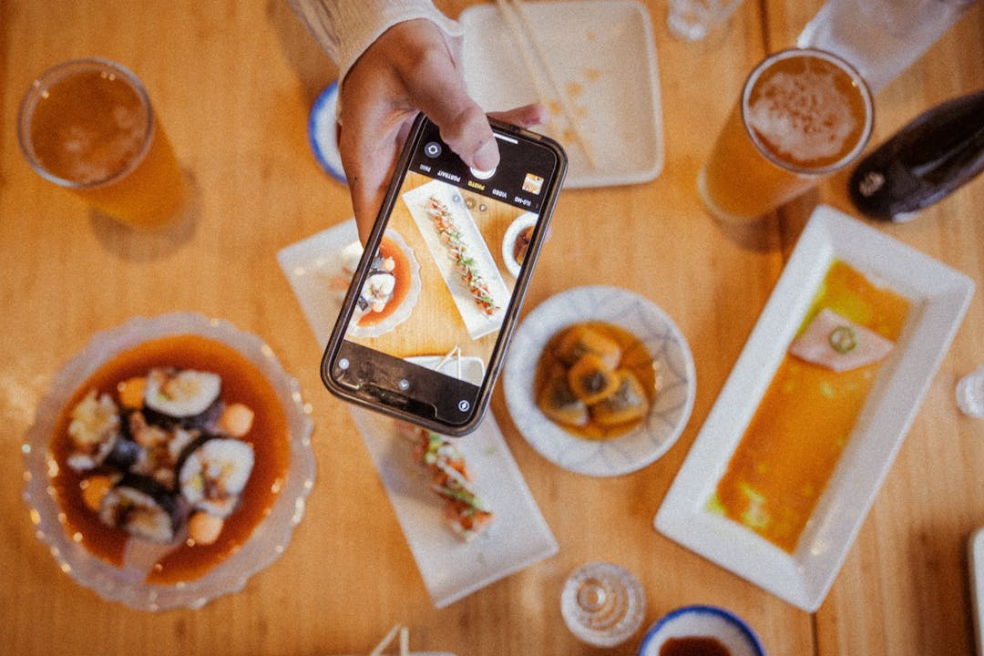 person taking aerial photo of sushi on a table
